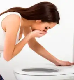 Woman vomiting in the toilet
