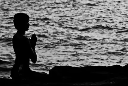Man praying on the beach